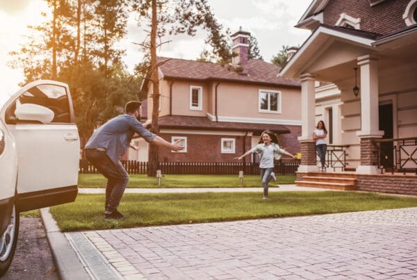 Home & Auto Bundle in Henrico County, VA - Father Parked Infront of Home with Daughter Running Towards Him and Mother Watching from Porch in the Distance
