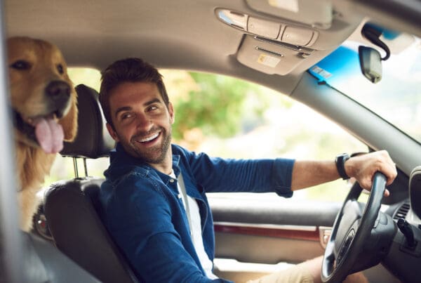 Cheap Car Insurance - Mid 30s Man in Drivers Seat with Golden Retriever in Back